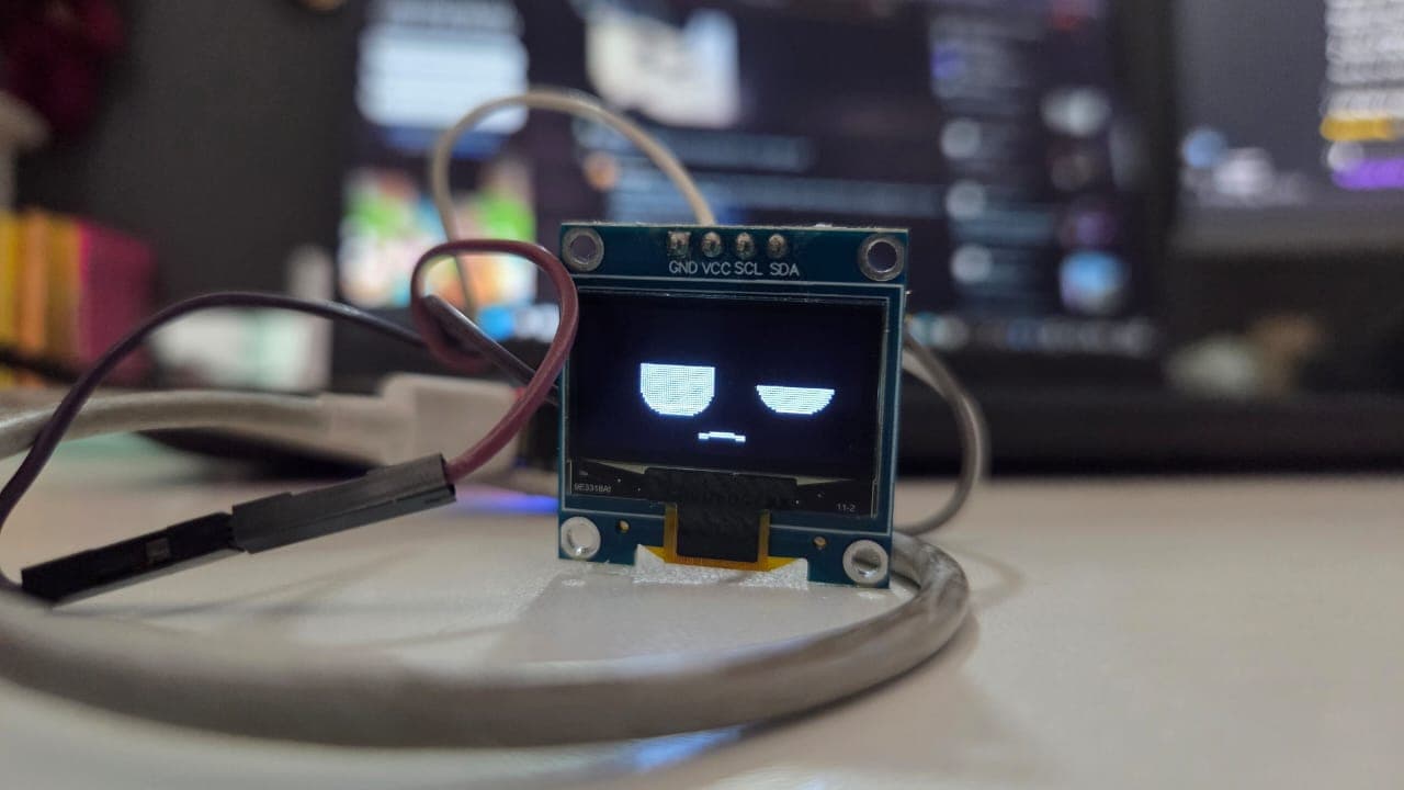First sign of life — the face running on an SSD1306 OLED over I2C, before it has a body to live in.